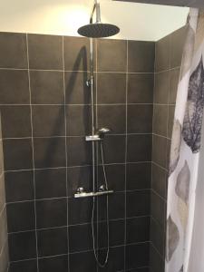 a shower with a shower head in a bathroom at Holiday Home Near Nordstrand Nykøbing Sj in Nykøbing Sjælland +8 photos