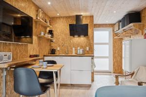 a small kitchen with a table and chairs at Small Oasis Near Coast And Town in Ebeltoft