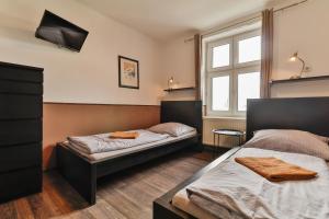 a bedroom with two beds and a window at Hostel u Arény in Ostrava