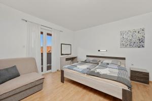 a white bedroom with a bed and a couch at Guesthouse Marija II in Lopar +85 photos