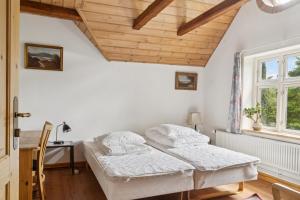 a bedroom with a bed and a desk and a window at Margretehøj Manor In Scenic Surroundings in Grenå +32 photos