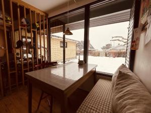 a dining room with a table and a large window at Charming And Cozy Cottage in Tranekær +24 photos