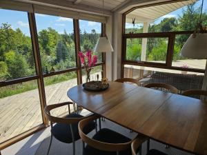 a dining room with a wooden table and chairs at Fantastic House With A Beautiful View in Ebeltoft