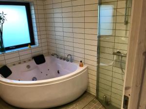 a bath tub in a bathroom with a window at Fantastic House With A Beautiful View in Ebeltoft +12 photos