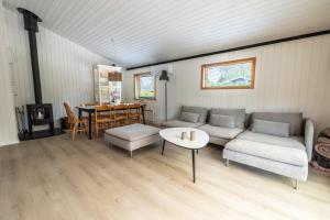 a living room with a couch and a table at The Pearl In Marielyst in Bøtø By