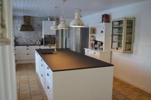 a kitchen with white cabinets and a black counter top at Large Holiday Home In Seaside Hotel Style in Ans +32 photos