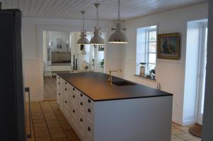 a kitchen with a counter with a sink in it at Large Holiday Home In Seaside Hotel Style in Ans