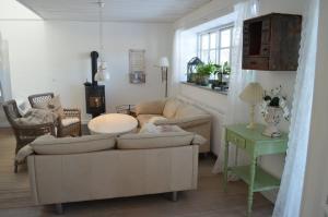 a living room with a couch and a table at Large Holiday Home In Seaside Hotel Style in Ans