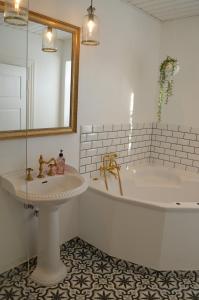 a white bathroom with a tub and a sink at Large Holiday Home In Seaside Hotel Style in Ans