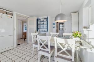 a kitchen and dining room with a table and chairs at Family-Friendly Beachside Holiday Home in Rønne +18 photos