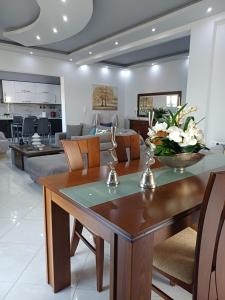 a living room with a dining table and a couch at Luxury apartment in Amarynthos +21 photos