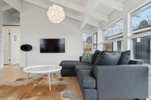 a living room with a couch and a table at Cozy Holiday Home On Orø in Orø