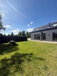 a house with a lawn in front of a building at Rosies Lodge in Kilkenny