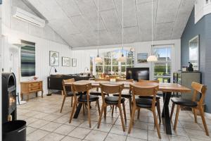 a dining room with a table and chairs at Super Nice Holiday Home With Whirlpool in Højslev +20 photos