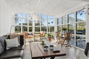 a living room with a couch and a table at Super Nice Holiday Home With Whirlpool in Højslev