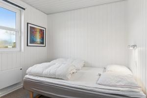 a white room with a bed with white sheets at Super Nice Holiday Home With Whirlpool in Højslev