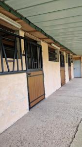 a row of doors on the side of a building at Écurie deL Luna in Cré-sur-Loir