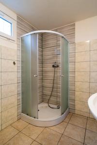 a shower with a glass door in a bathroom at Autokemp Křivonoska in České Budějovice