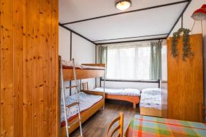 a room with two bunk beds and a table at Autokemp Křivonoska in České Budějovice