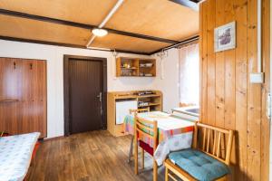 a kitchen with a table and chairs in a room at Autokemp Křivonoska in České Budějovice