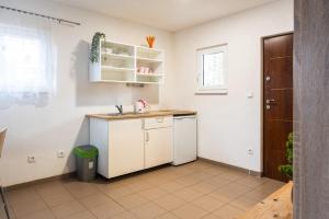 a white kitchen with a sink and a counter at Autokemp Křivonoska in České Budějovice