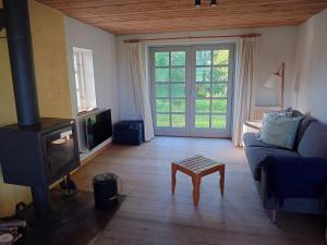 a living room with a couch and a tv at Idyllic Half-Timbered House For 10 Guests in Kettinge
