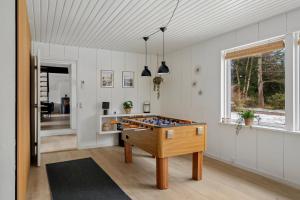 a room with a ping pong table in it at Holiday Home With Spa Sauna And Hot Tub in Farsø