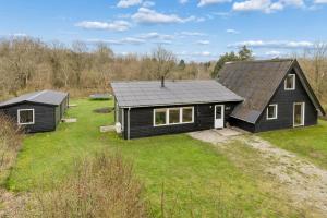 an aerial view of a black house with a yard at Holiday Home With Spa Sauna And Hot Tub in Farsø