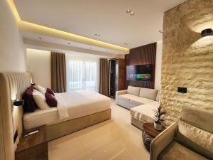 a hotel room with a bed and a couch at Villa LaMia in Ulcinj