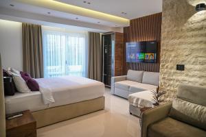 a hotel room with a bed and a couch at Villa LaMia in Ulcinj