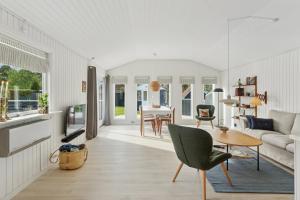a living room with a couch and a table at Quiet Holiday Home With Annex And Great Outdoor in Bogø By