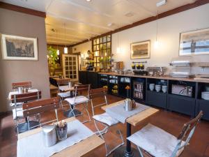 a restaurant with tables and chairs and a counter at Smart Stay Hotel Station in Munich