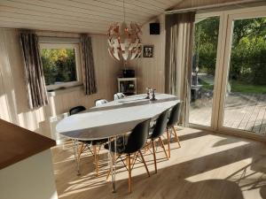 a dining room with a large white table and chairs at Fantastic Spa Holiday Home in Hemmet