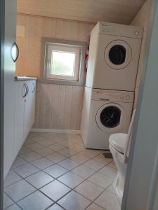 a small laundry room with a washer and dryer at Fantastic Spa Holiday Home in Hemmet +5 photos