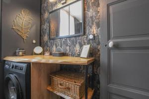 a bathroom with a sink and a washing machine at Les halles du temps in Bar-sur-Seine +16 photos