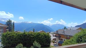 a view of a town with mountains in the background at Panorama 14 in Bagnes +2 photos