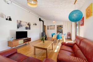 a living room with a couch and a table at Gite Le Koto in Thorigny