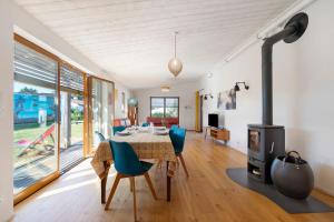 a living room with a table and a fireplace at Gite Le Koto in Thorigny