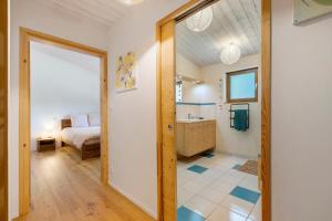 a bedroom with a bed and a bathroom at Gite Le Koto in Thorigny +28 photos