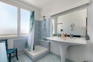 a bathroom with a sink and a shower and a tub at Vacances chez Lulu in Batz-sur-Mer +23 photos