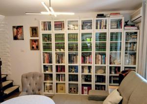 a large white book case with books in it at Villa Golda, The whole house Biker Friendly in Rijeka Reževići