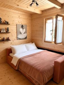 a bedroom with a large bed in a wooden room at Holiday house Flores near Kolasin in Kolašin