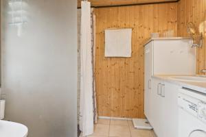 a bathroom with a sink and a toilet at Summerhouse In Peaceful Surroundings in Pandrup +17 photos