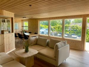 a living room with a couch and a table at 2-Family Activity Cottage in Rønde