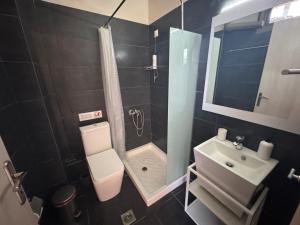 a bathroom with a toilet and a shower and a sink at nafsea in Afitos +34 photos