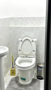 a bathroom with a white toilet and a sink at Dom Hostel in Samarkand +33 photos