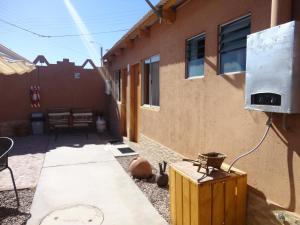 a fire hydrant sitting on the side of a building at Hostal Pablito in San Pedro de Atacama
