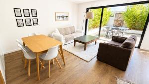 a living room with a table and a couch at Les Oiseaux de Loire in Les Ponts-de-Cé
