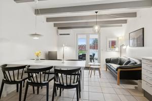a kitchen and living room with a table and chairs at Holiday Apartment With Sea View in Hadsund +17 photos