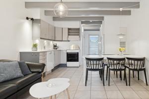 a kitchen and living room with a couch and a table at Holiday Apartment With Sea View in Hadsund